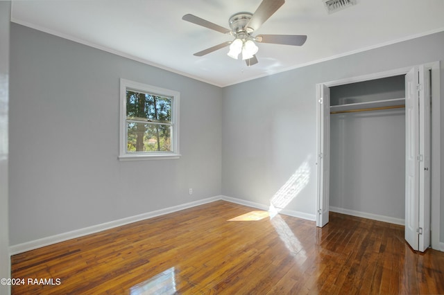 unfurnished bedroom with ceiling fan, a closet, crown molding, and dark hardwood / wood-style floors