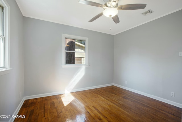 spare room featuring a wealth of natural light, ceiling fan, ornamental molding, and hardwood / wood-style flooring