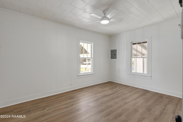 unfurnished room featuring ceiling fan, electric panel, and light wood-type flooring