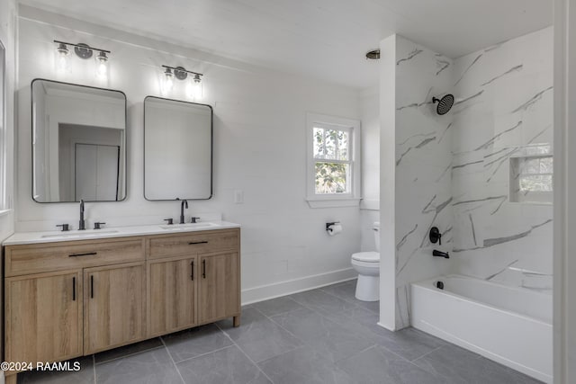 full bathroom with vanity, tiled shower / bath combo, and toilet