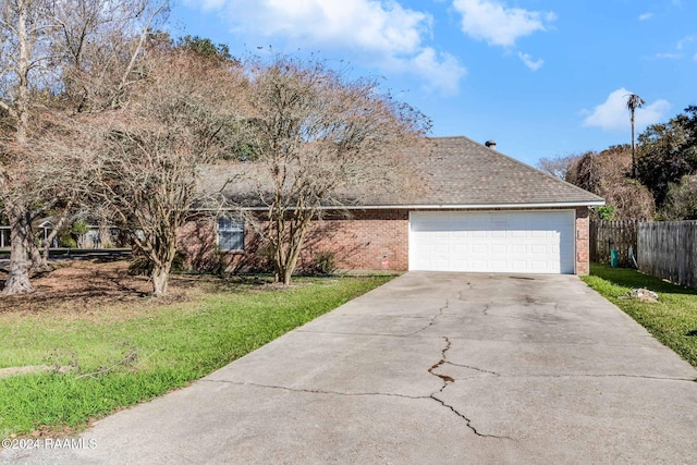 view of front of house with a garage and a front lawn