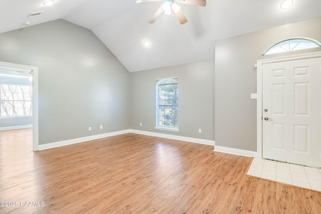 foyer with plenty of natural light, ceiling fan, lofted ceiling, and light wood finished floors