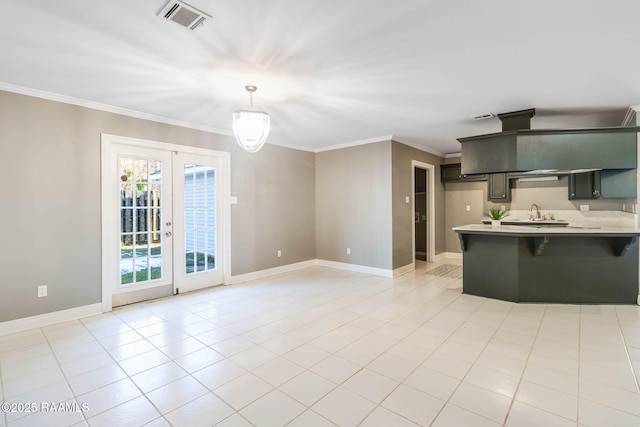 kitchen with a kitchen breakfast bar, ornamental molding, light tile patterned floors, kitchen peninsula, and french doors