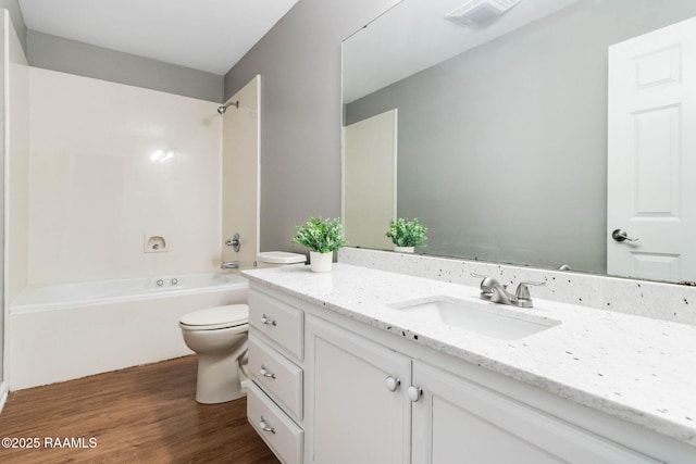 bathroom featuring tub / shower combination, wood finished floors, vanity, visible vents, and toilet