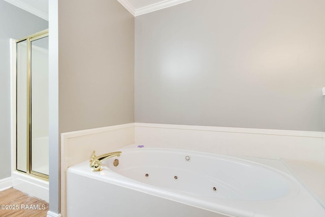 full bath featuring a shower stall, ornamental molding, wood finished floors, and a whirlpool tub