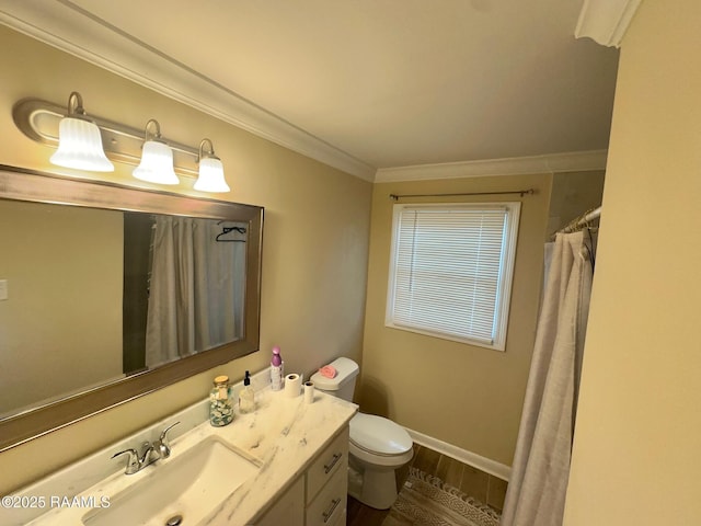 bathroom with baseboards, ornamental molding, toilet, wood finished floors, and vanity