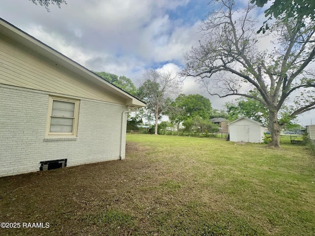 view of yard with an outbuilding, fence, and a storage shed