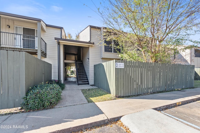 view of front of house with a fenced front yard and stairs