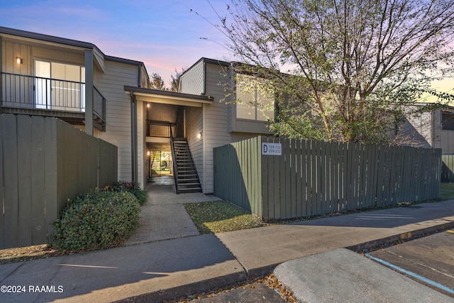 view of front facade with a fenced front yard and stairs