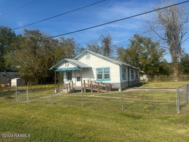 back of property featuring a lawn