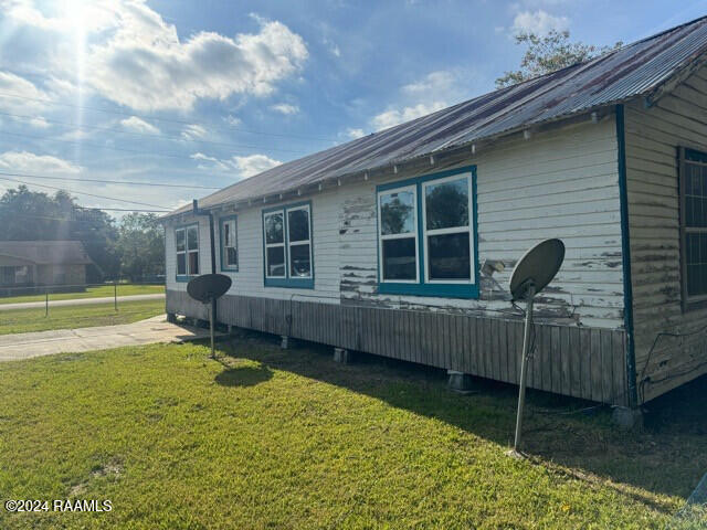 view of side of home with a lawn