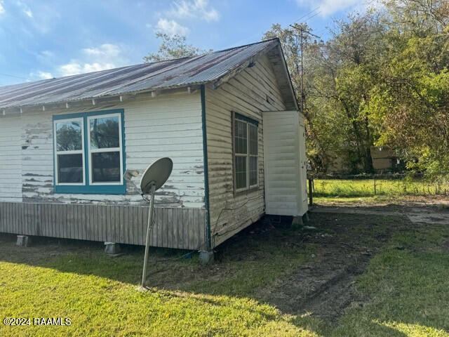 view of property exterior with a yard