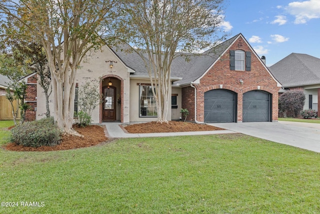 view of front of property with a garage and a front lawn