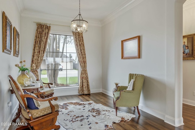 living area with hardwood / wood-style flooring, plenty of natural light, and crown molding