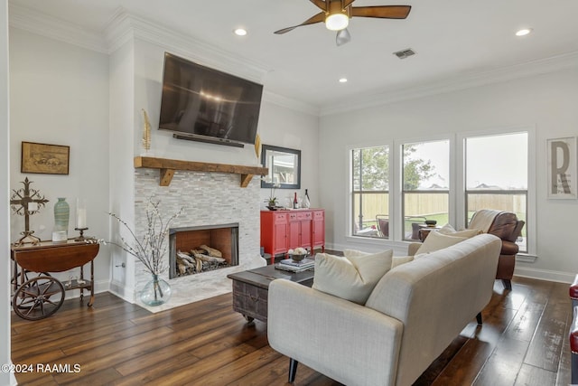 living room with ceiling fan, a fireplace, ornamental molding, and dark hardwood / wood-style flooring