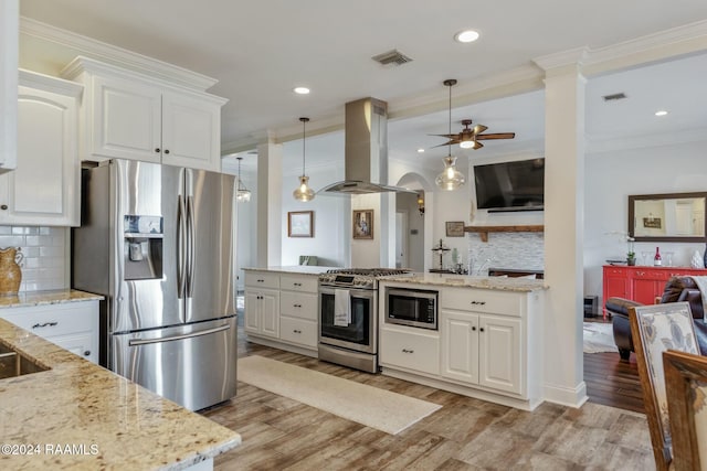 kitchen with stainless steel appliances, island exhaust hood, pendant lighting, and white cabinets