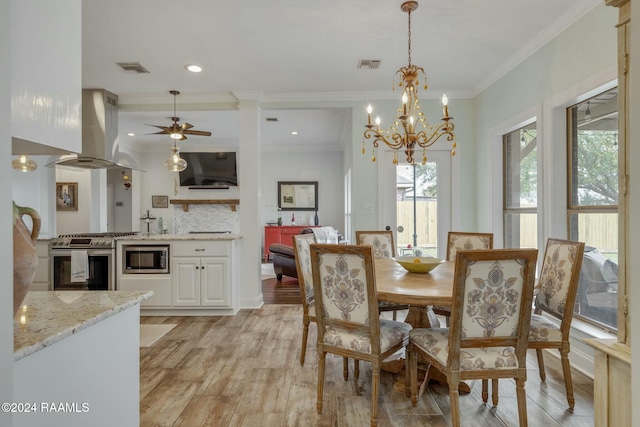 dining room featuring crown molding, a chandelier, and light hardwood / wood-style flooring