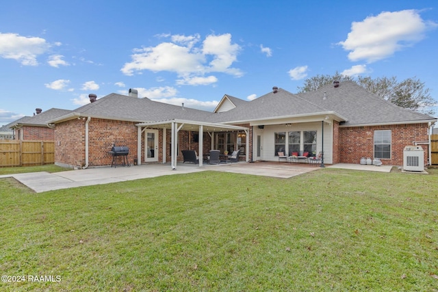 back of property featuring a yard and a patio area