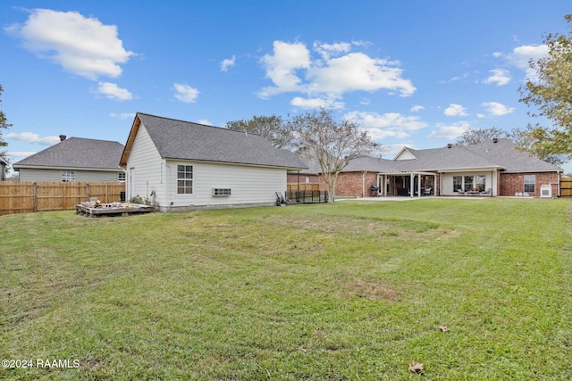 rear view of property with a yard and a patio