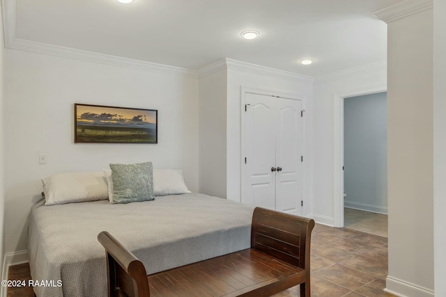 bedroom featuring crown molding, tile patterned floors, and a closet