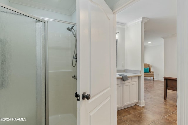 bathroom with vanity, tile patterned flooring, crown molding, and a shower with shower door