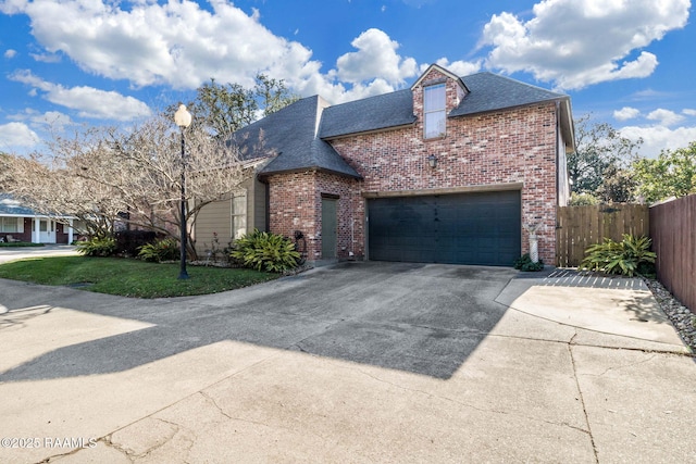 view of front of property with a garage and a front lawn