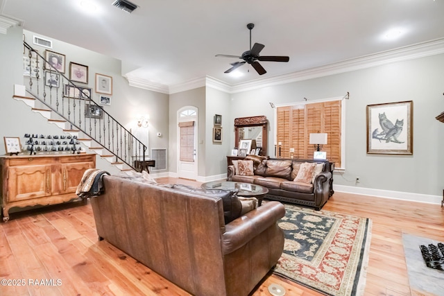 living room with ceiling fan, light hardwood / wood-style floors, and ornamental molding