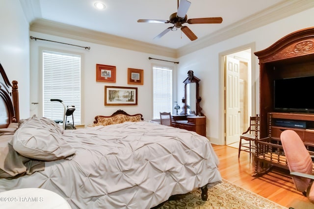 bedroom featuring light hardwood / wood-style floors, ceiling fan, and crown molding