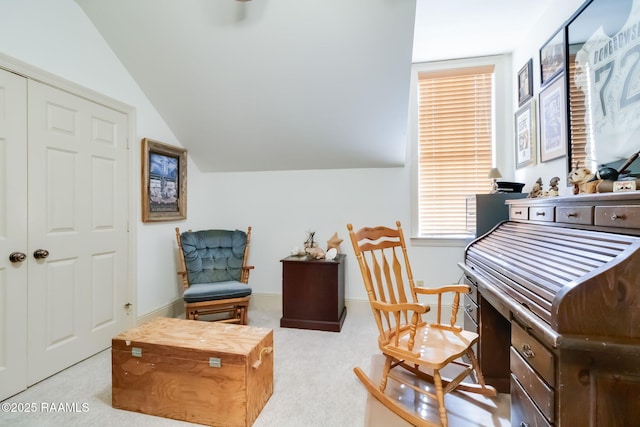 sitting room featuring light colored carpet and lofted ceiling