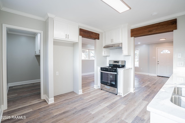 kitchen featuring white cabinetry, stainless steel range with gas cooktop, crown molding, and light stone countertops