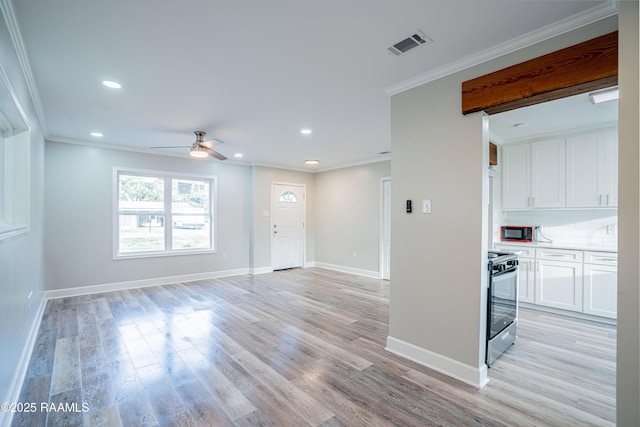 unfurnished living room with crown molding, ceiling fan, and light hardwood / wood-style floors