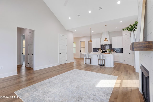 320 Dunvegan Ct, Lafayette, LA 70503 - living room featuring high vaulted ceiling, light wood-style floors, a fireplace, and recessed lighting