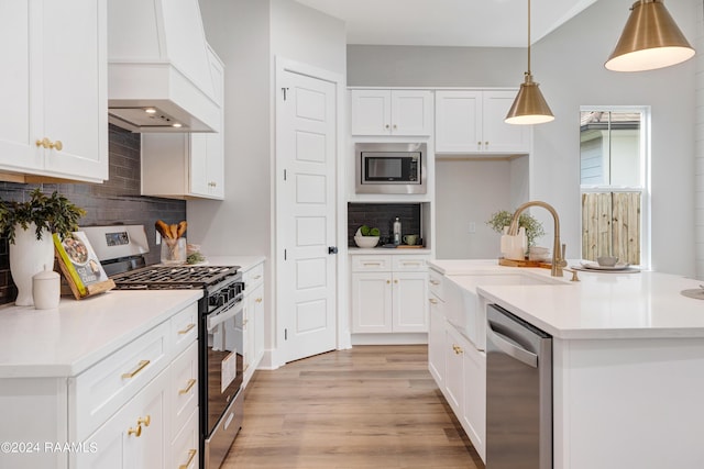 320 Dunvegan Ct, Lafayette, LA 70503 - kitchen featuring stainless steel appliances, custom exhaust hood, tasteful backsplash, light wood-type flooring, and white cabinetry