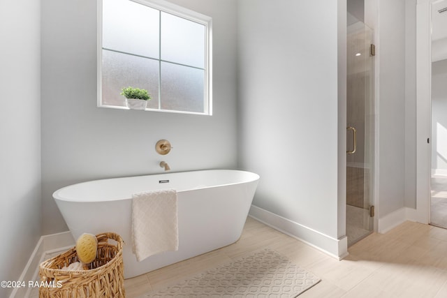 bathroom featuring separate shower and tub and plenty of natural light