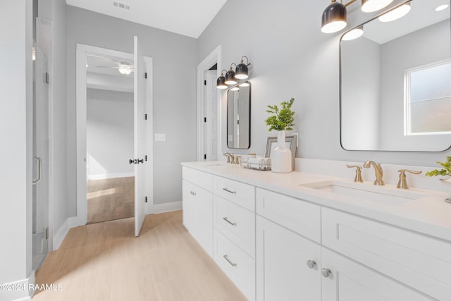 bathroom with hardwood / wood-style floors, vanity, and ceiling fan