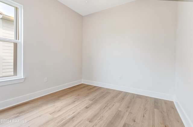 empty room with light hardwood / wood-style flooring