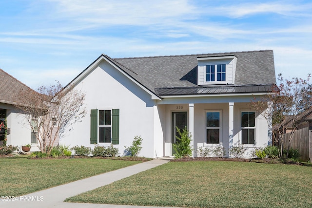 320 Dunvegan Ct, Lafayette, LA 70503 - view of front of house featuring stucco siding, a metal roof, a porch, a standing seam roof, and roof with shingles