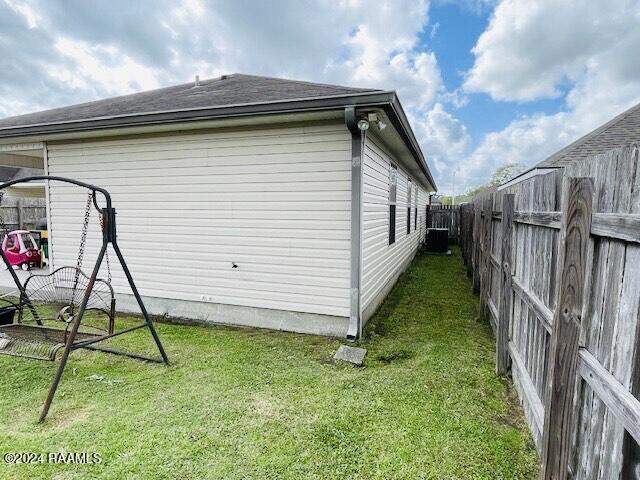 view of side of home with a lawn