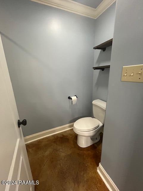 bathroom featuring toilet and ornamental molding