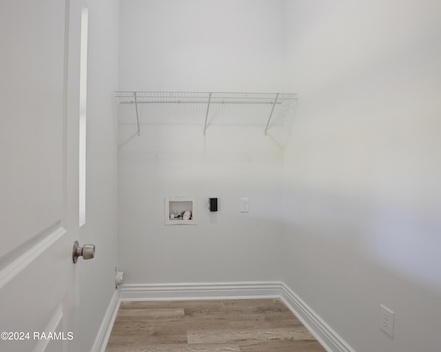 clothes washing area with electric dryer hookup, light hardwood / wood-style floors, and hookup for a washing machine