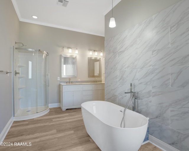 bathroom featuring hardwood / wood-style flooring, vanity, crown molding, and plus walk in shower