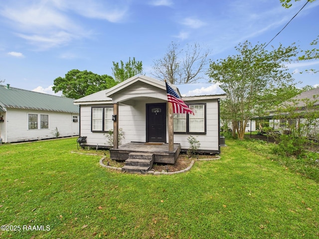 bungalow with a front lawn and metal roof
