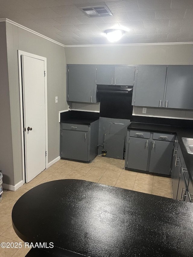 kitchen featuring ornamental molding, light tile patterned floors, and gray cabinets