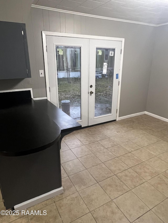 doorway to outside featuring french doors, light tile patterned floors, and crown molding