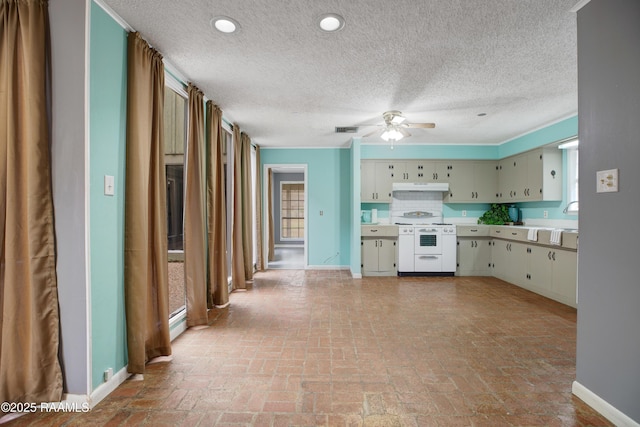 kitchen with ceiling fan, backsplash, a baseboard heating unit, white stove, and cream cabinetry