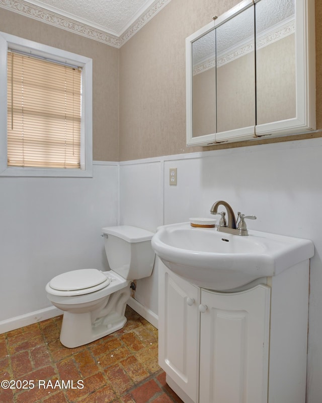 bathroom featuring toilet, a textured ceiling, and vanity