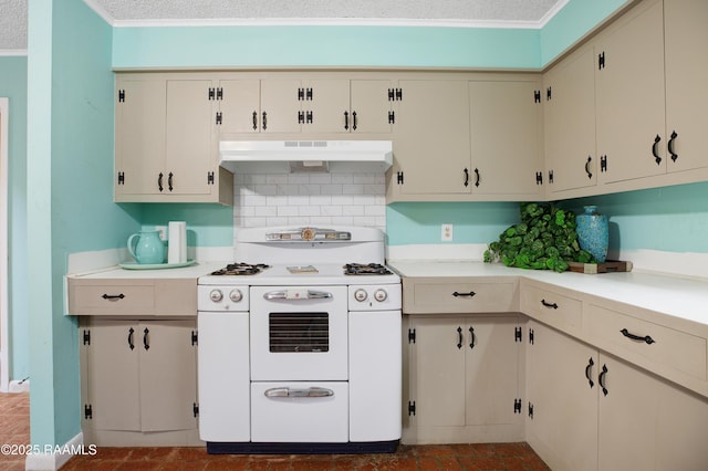 kitchen with crown molding, decorative backsplash, cream cabinetry, and white range