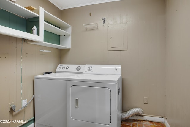 washroom featuring washer and clothes dryer, wooden walls, and electric panel