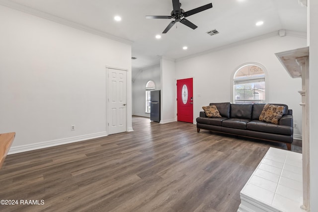 living room featuring dark hardwood / wood-style floors, vaulted ceiling, ceiling fan, and ornamental molding