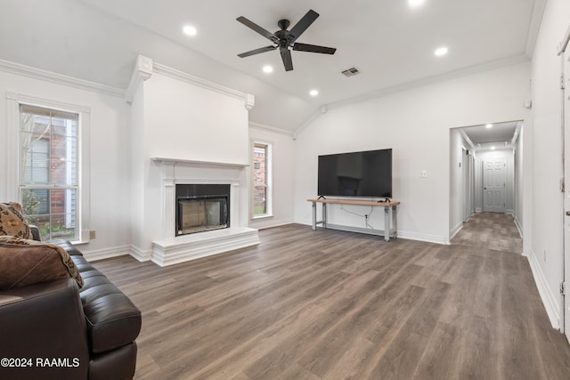 living room with crown molding, wood-type flooring, and vaulted ceiling